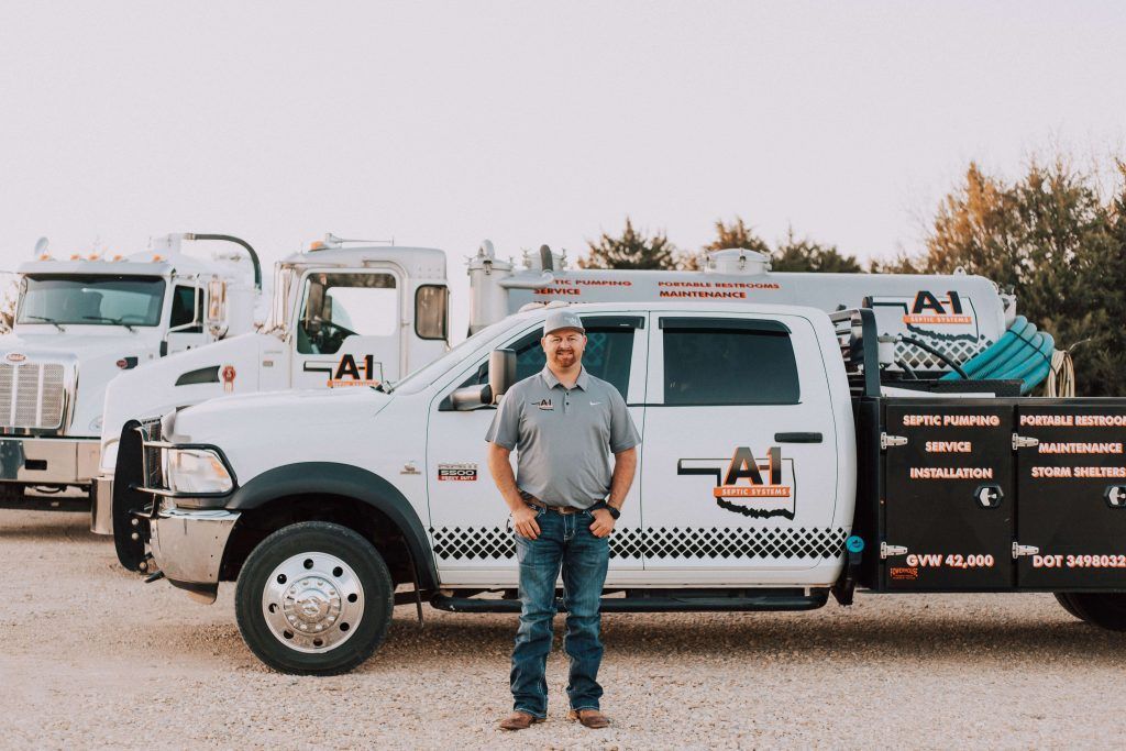 A man is standing in front of a white truck.
