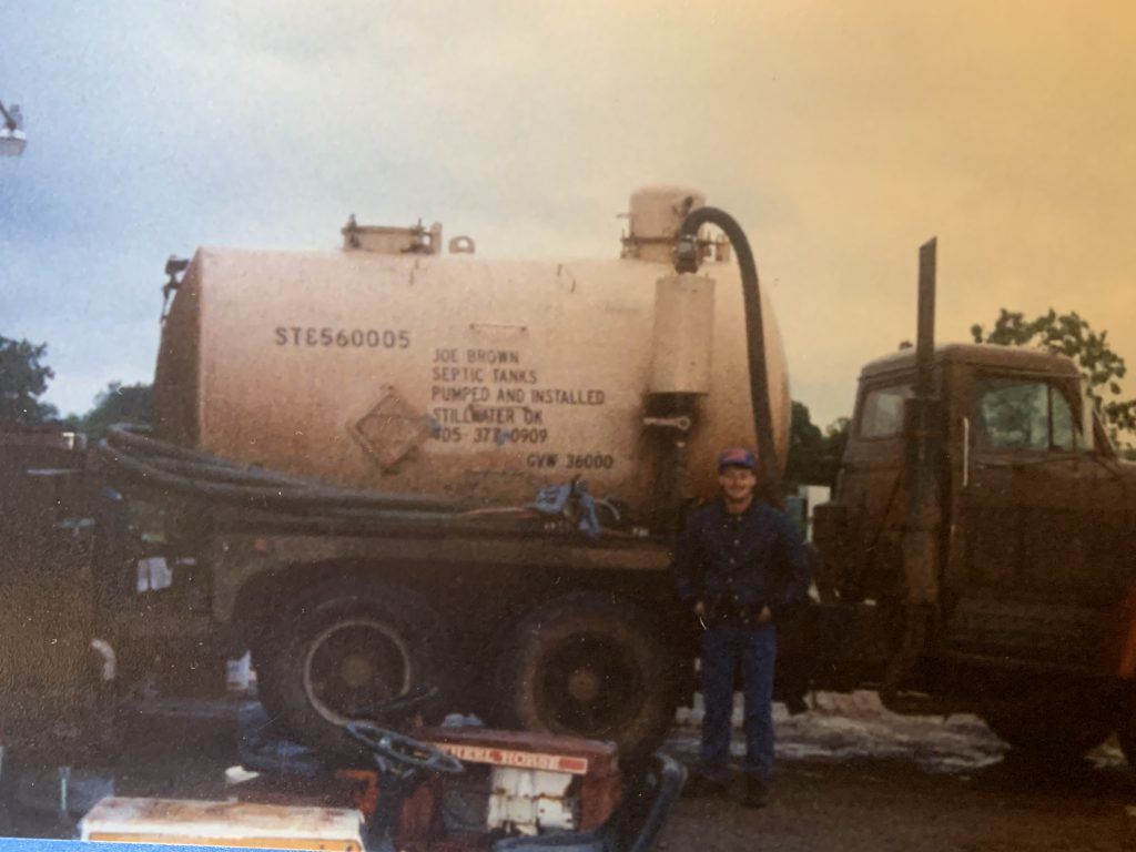 A man standing in front of a truck that says stc560505