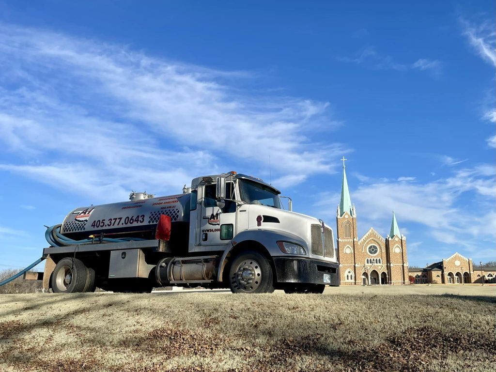 A large truck is parked in front of a church.