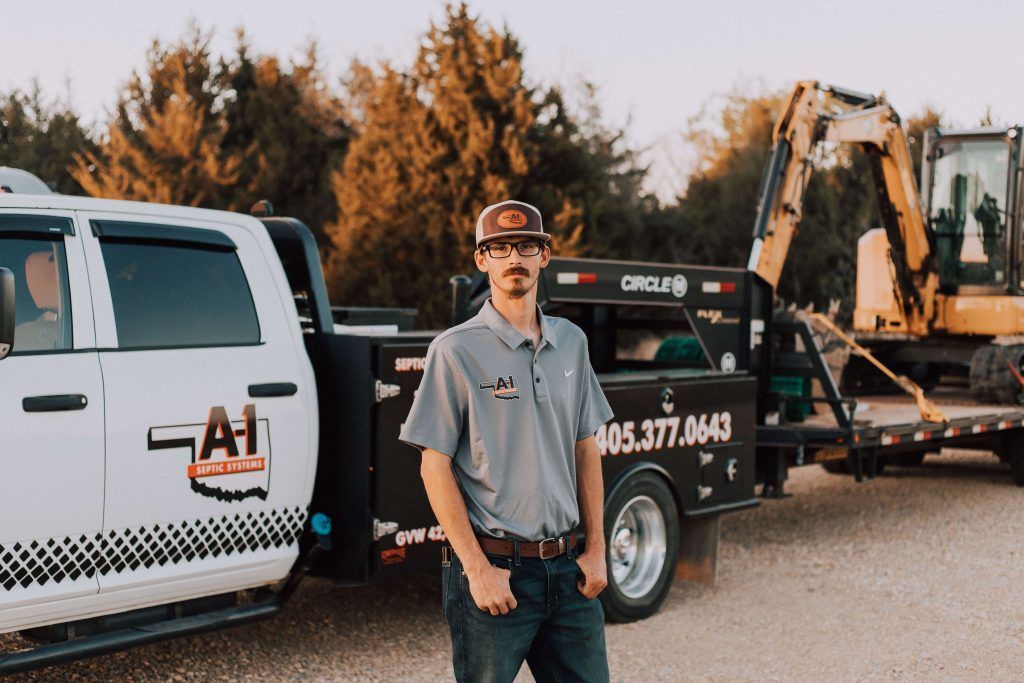 A man is standing in front of a truck.