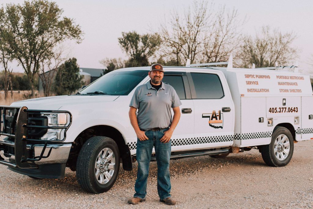 A man is standing in front of a white truck.