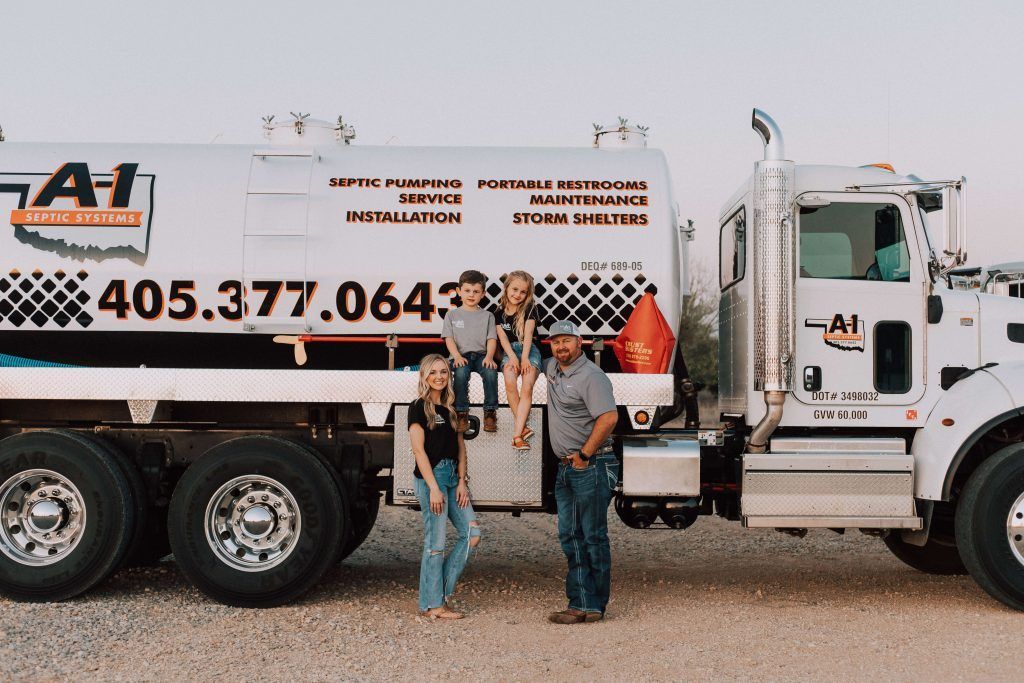 A group of people standing next to a large white truck.