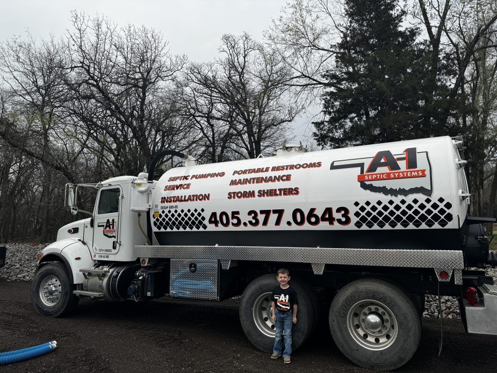 A boy stands in front of a white a1 truck
