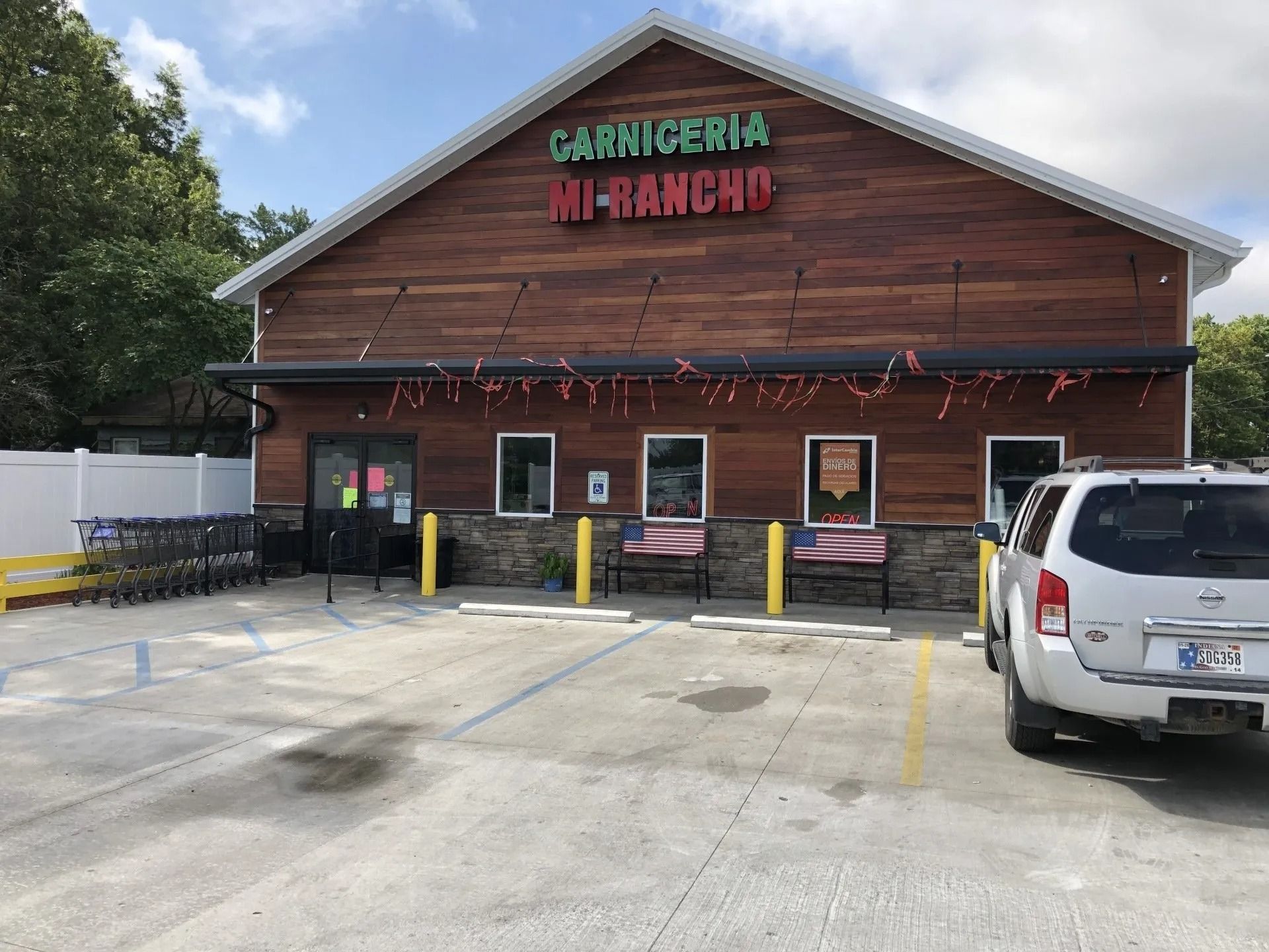 Carniceria Mi Rancho, a grocery store, with parking and a parked white SUV.