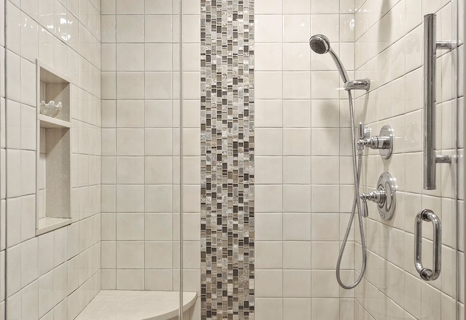 A bathroom with a walk in shower and a toilet.