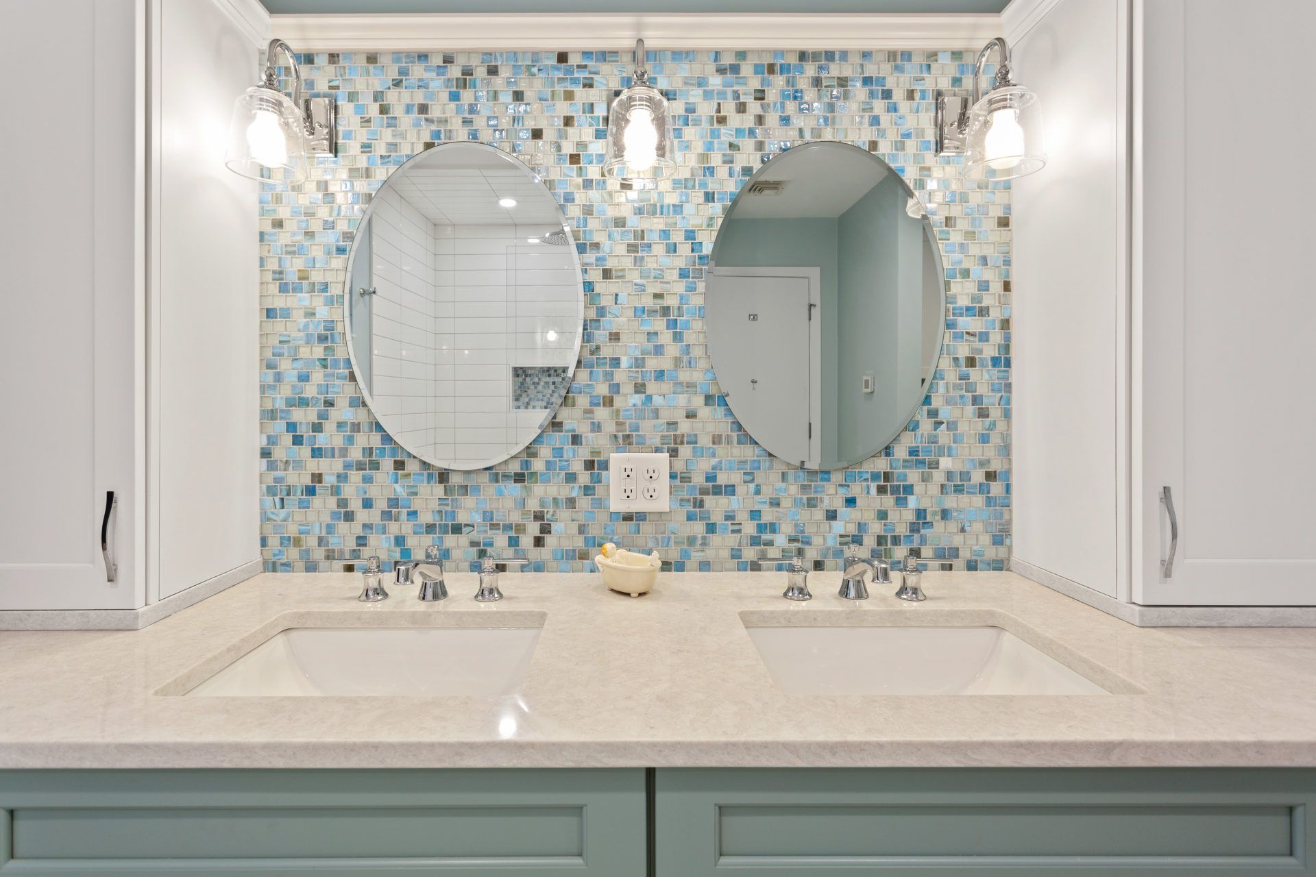 A bathroom with two sinks and two mirrors.