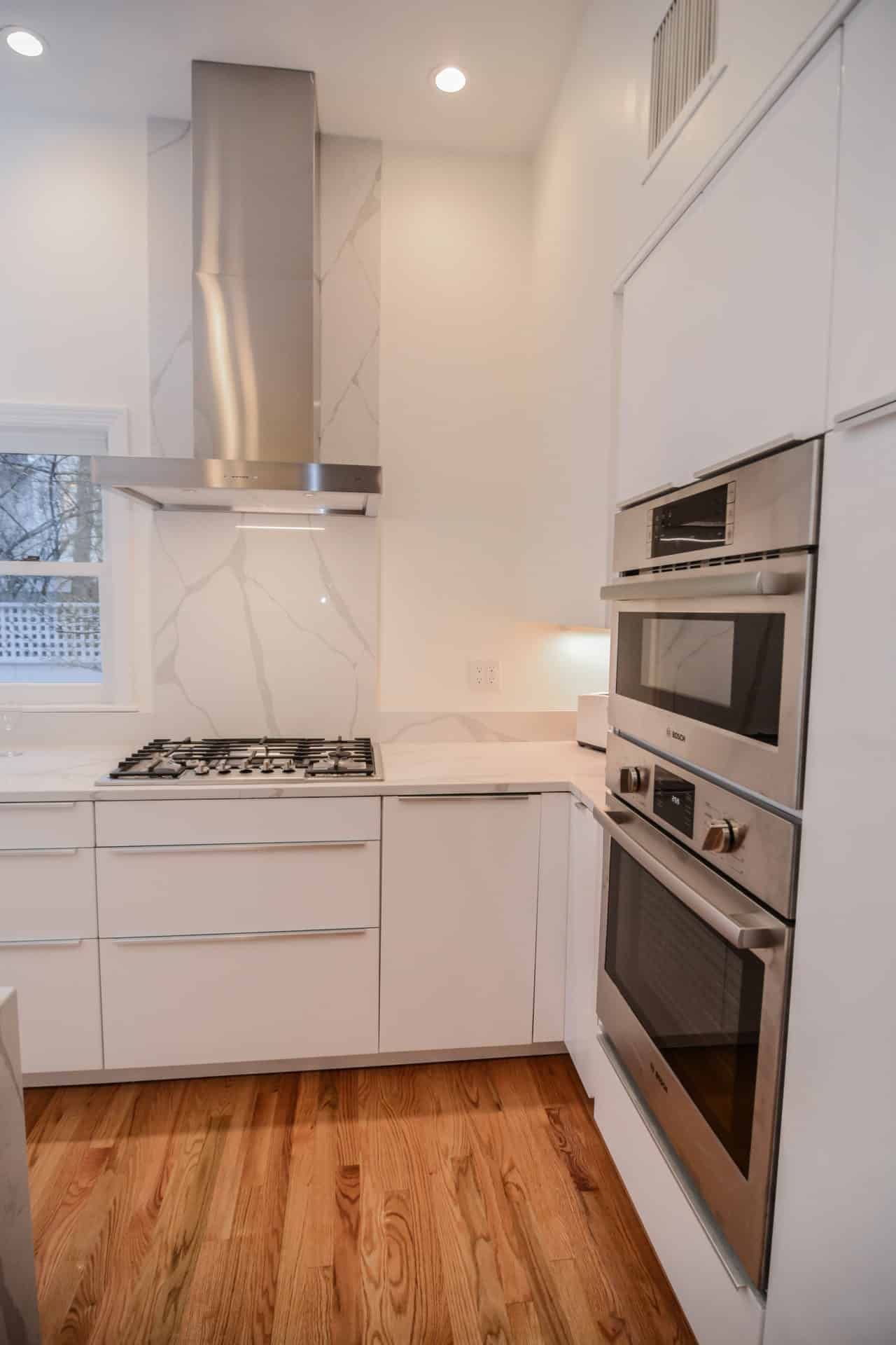 A kitchen with white cabinets and stainless steel appliances.