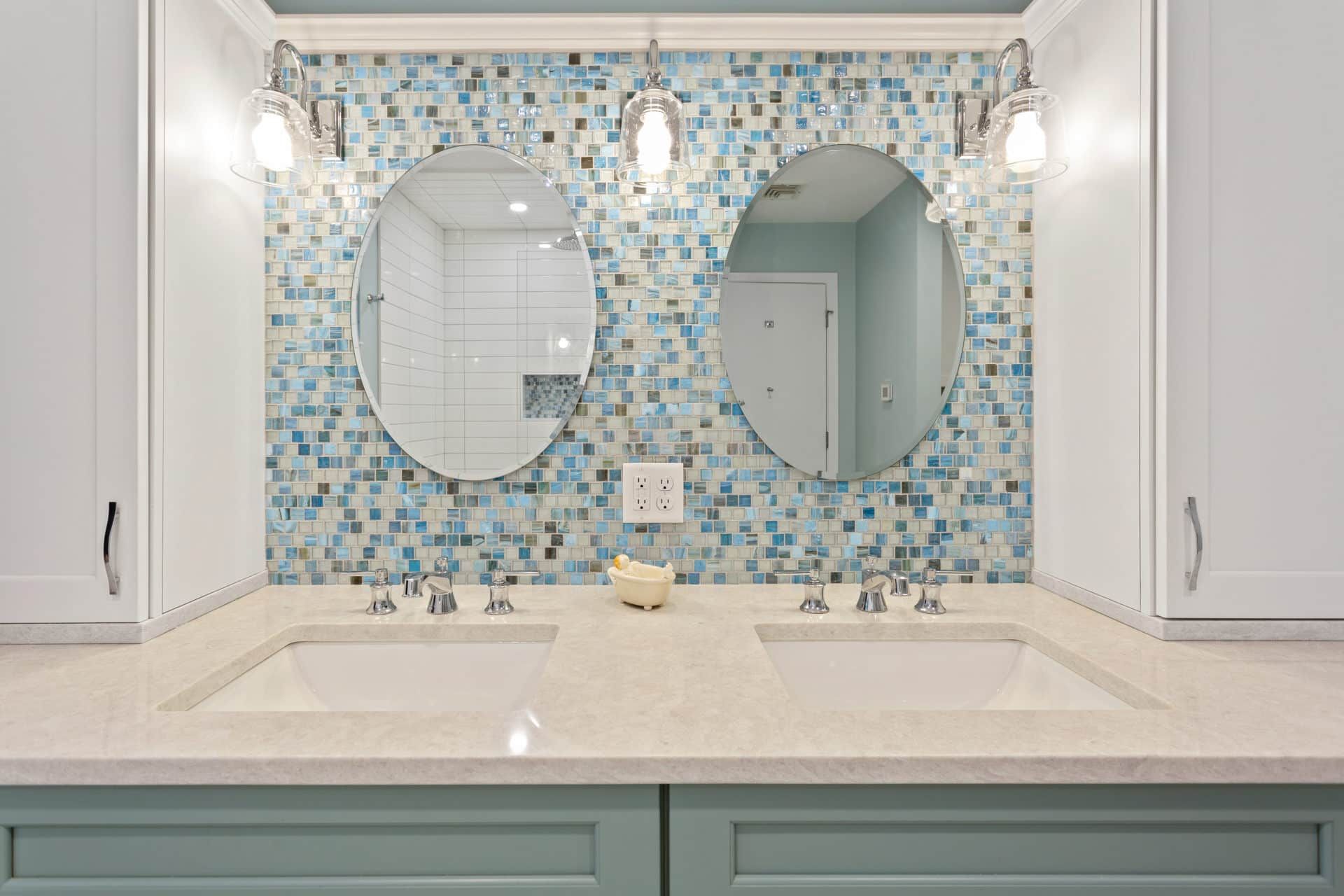 A bathroom with two sinks and two mirrors.