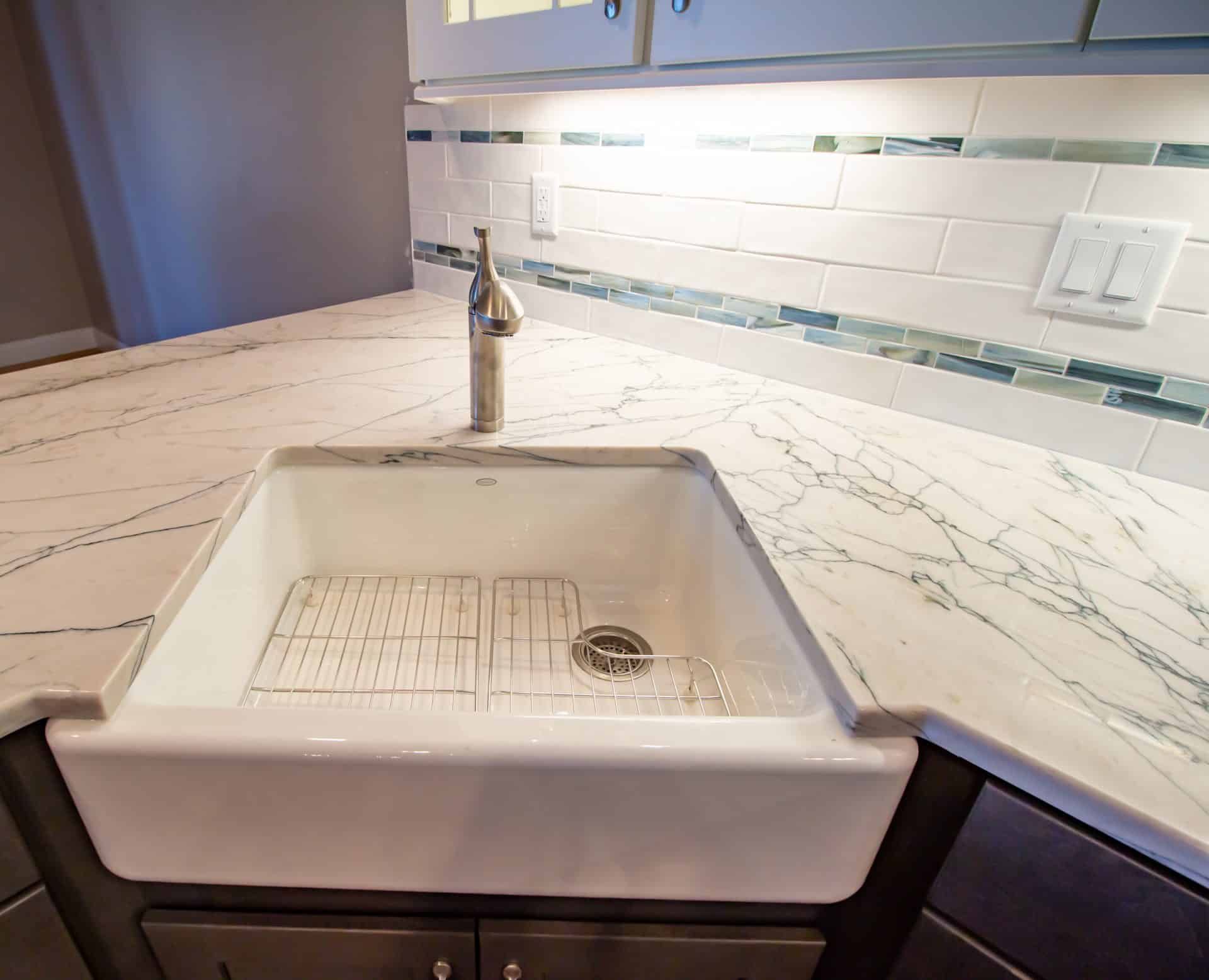 A kitchen with a sink and a faucet on the counter