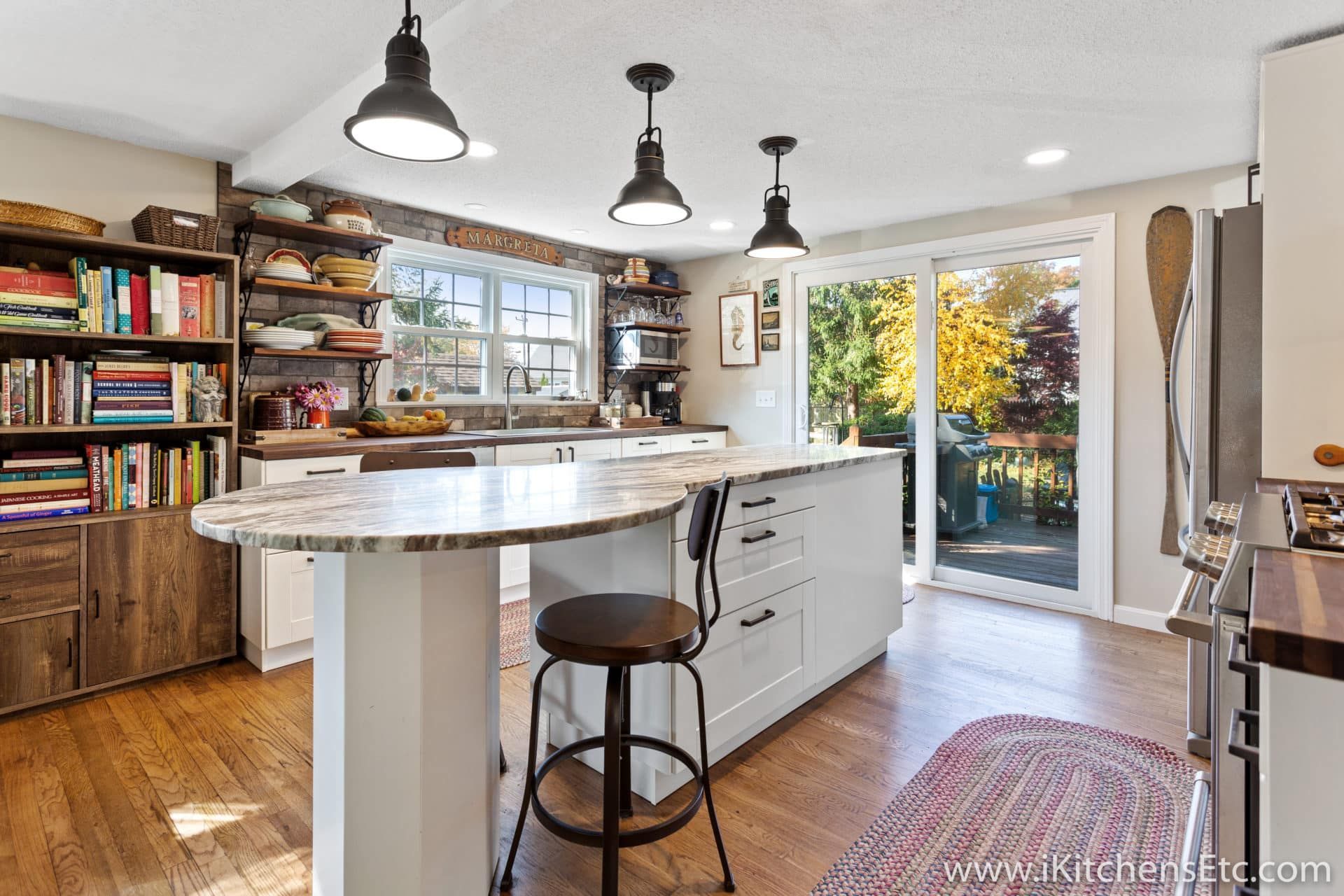 A kitchen with a large island and a sliding glass door