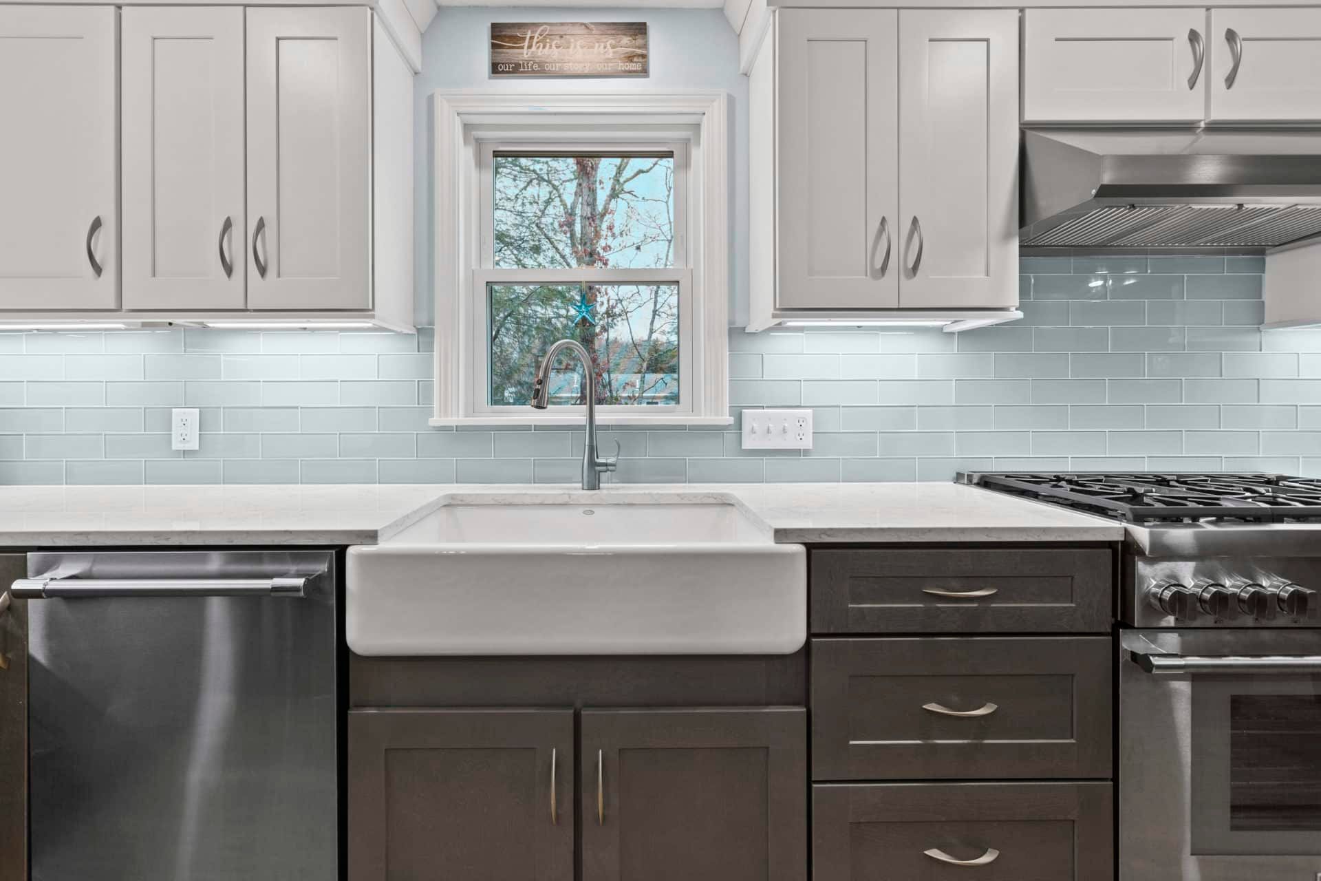 A kitchen with stainless steel appliances and a farmhouse sink.