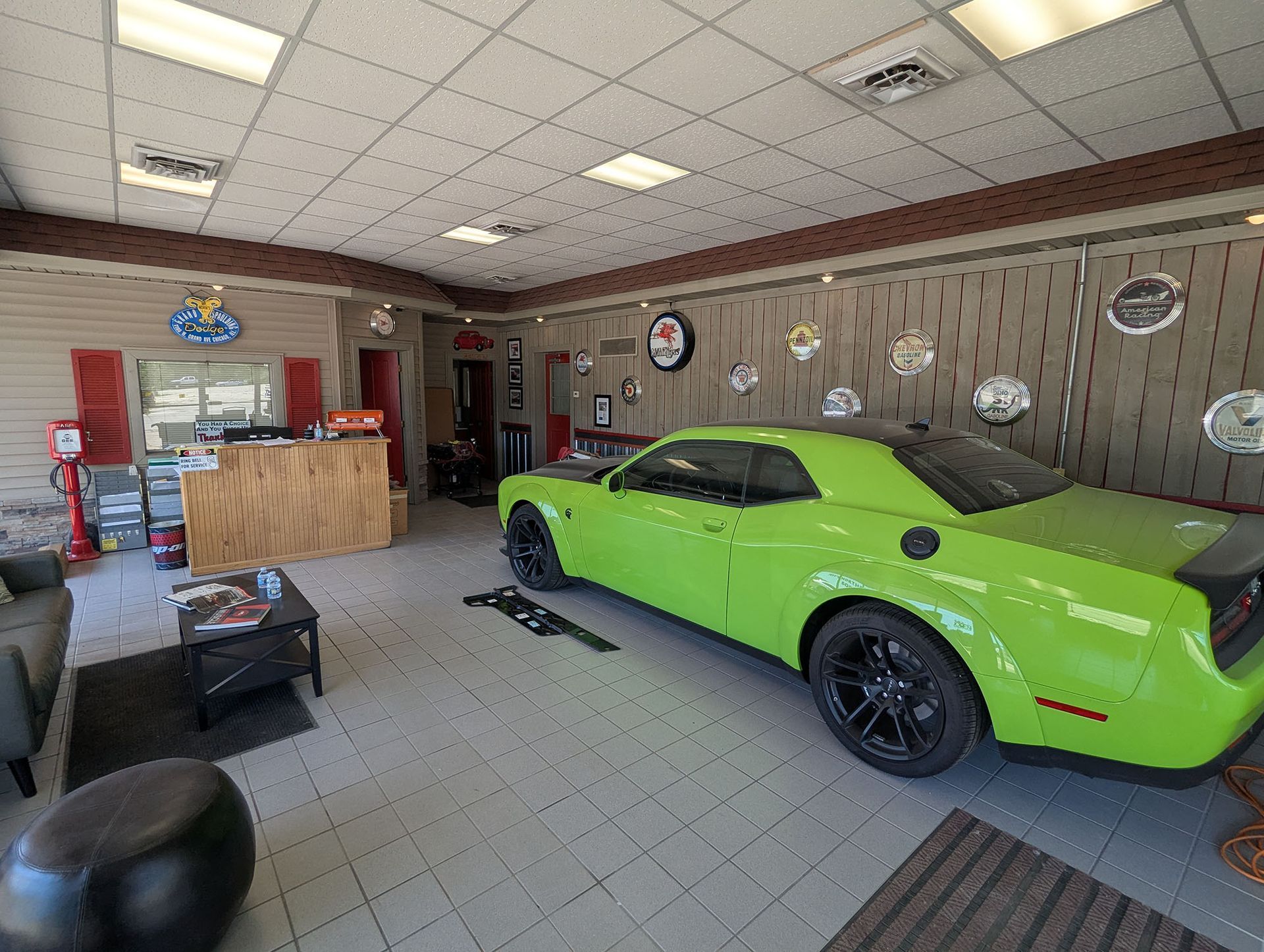 A car dealership with a lot of cars parked in front of it.