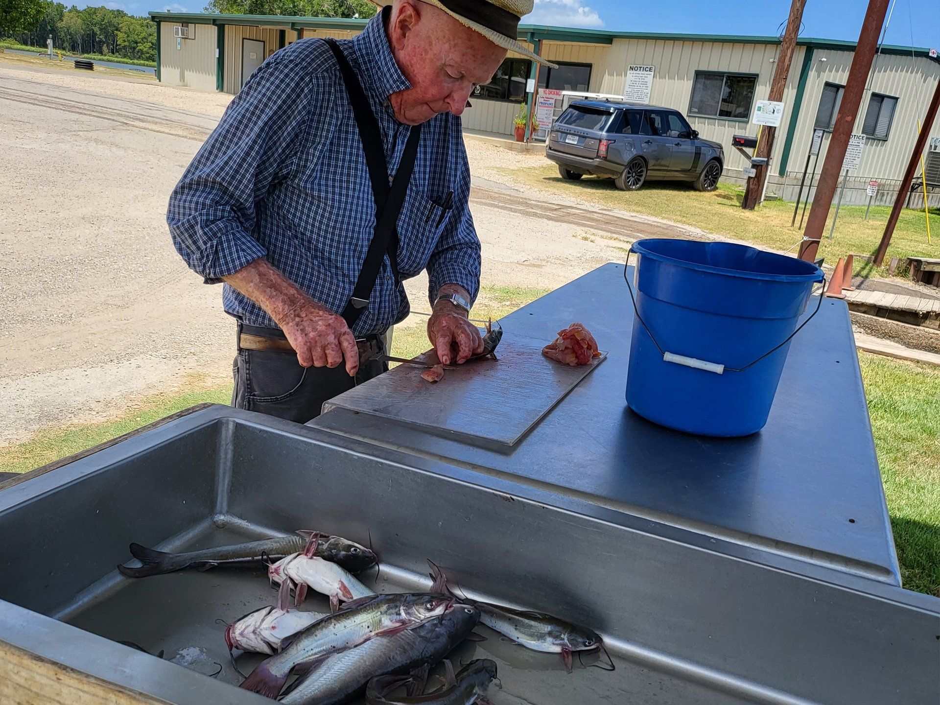 man cutting fresh caught fish