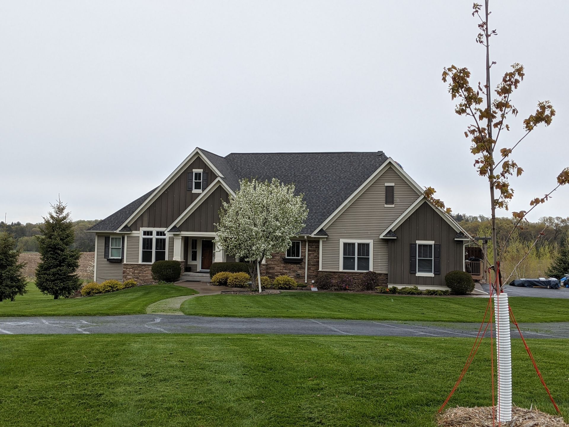 A large house with a tree in front of it.