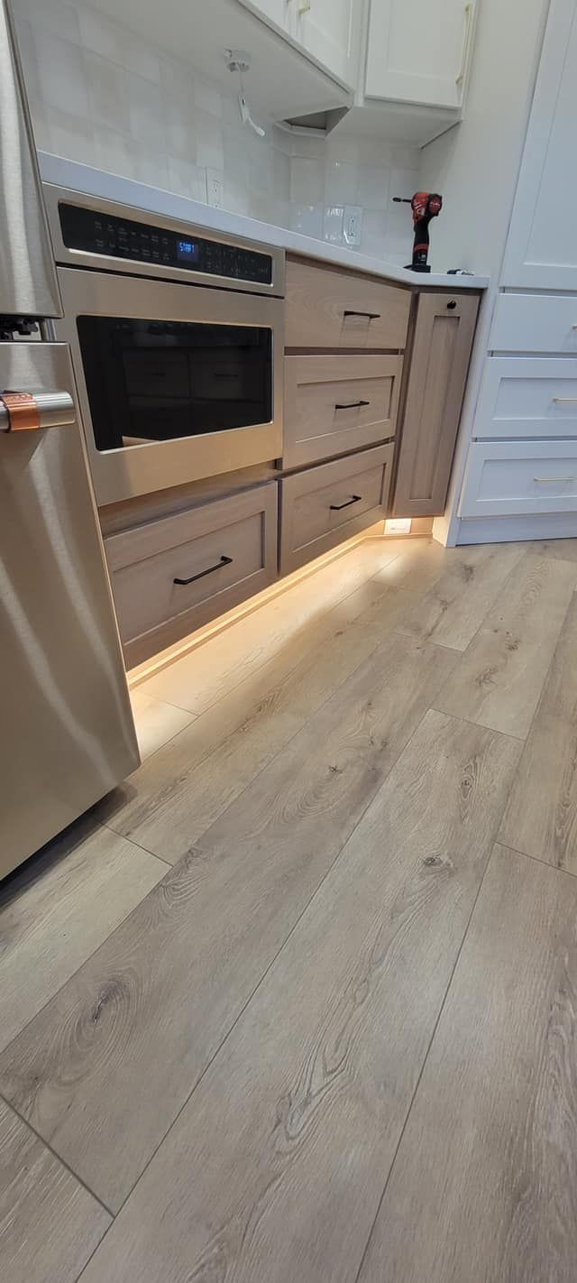 A kitchen with stainless steel appliances and wooden cabinets.