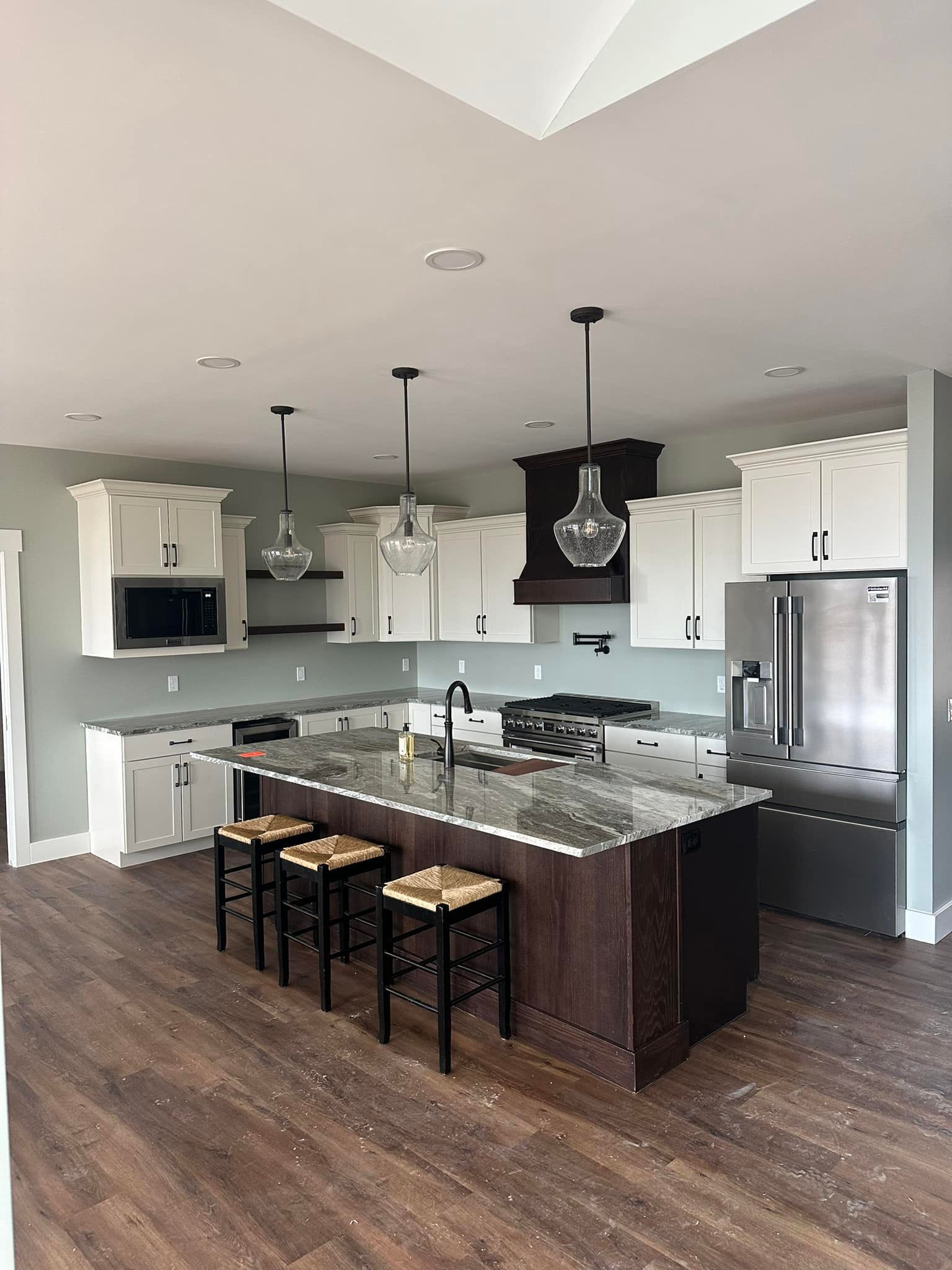 A kitchen with a large island and stools