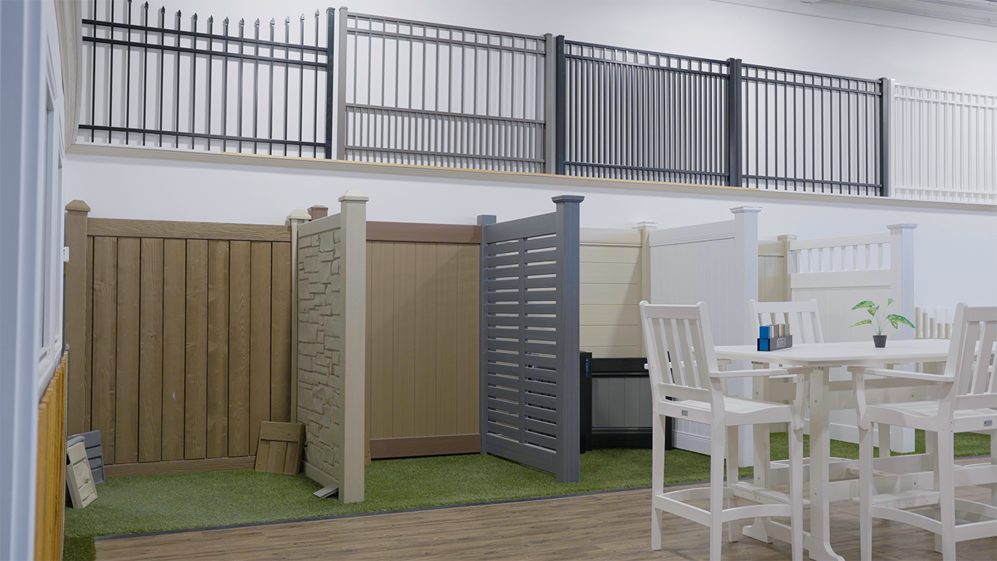 A room with a table and chairs and a fence in it.