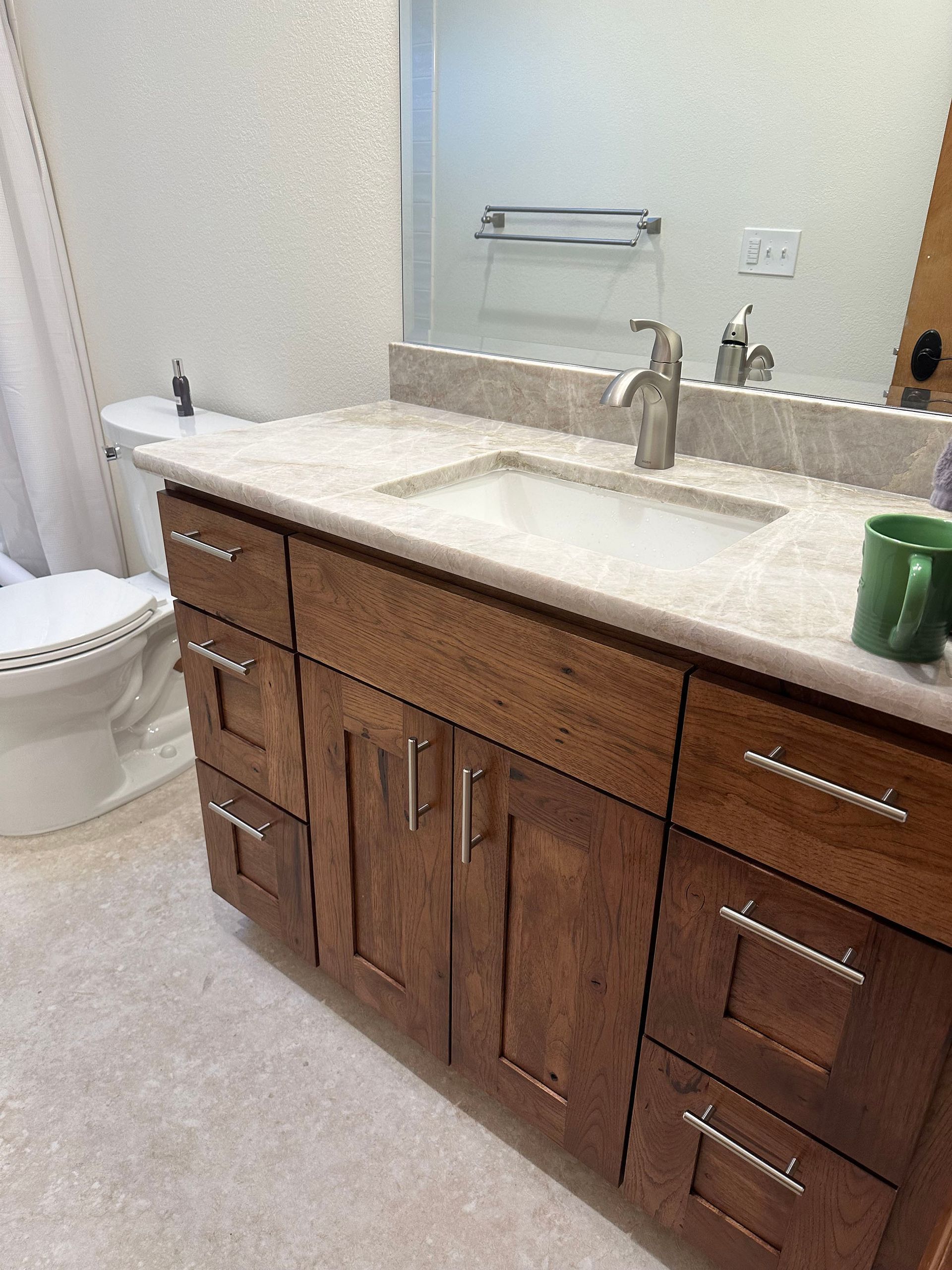 A bathroom with a sink , toilet , and mirror.