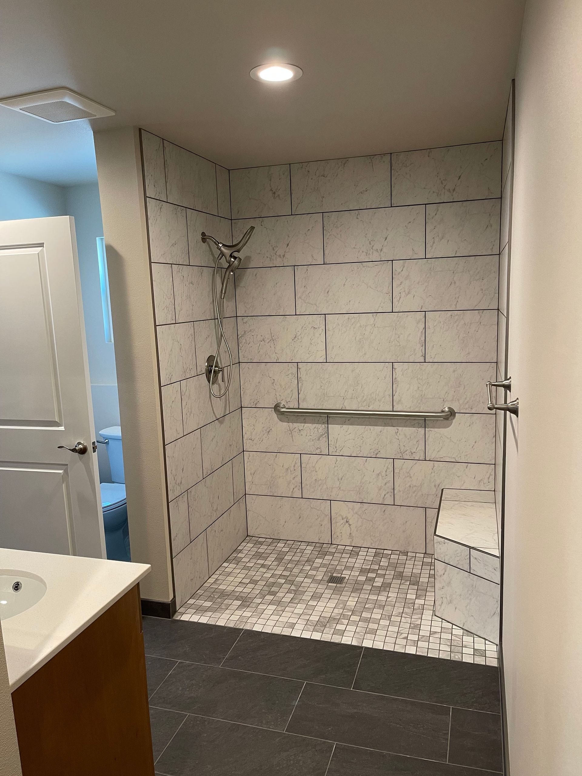 A bathroom with a walk in shower and a toilet.