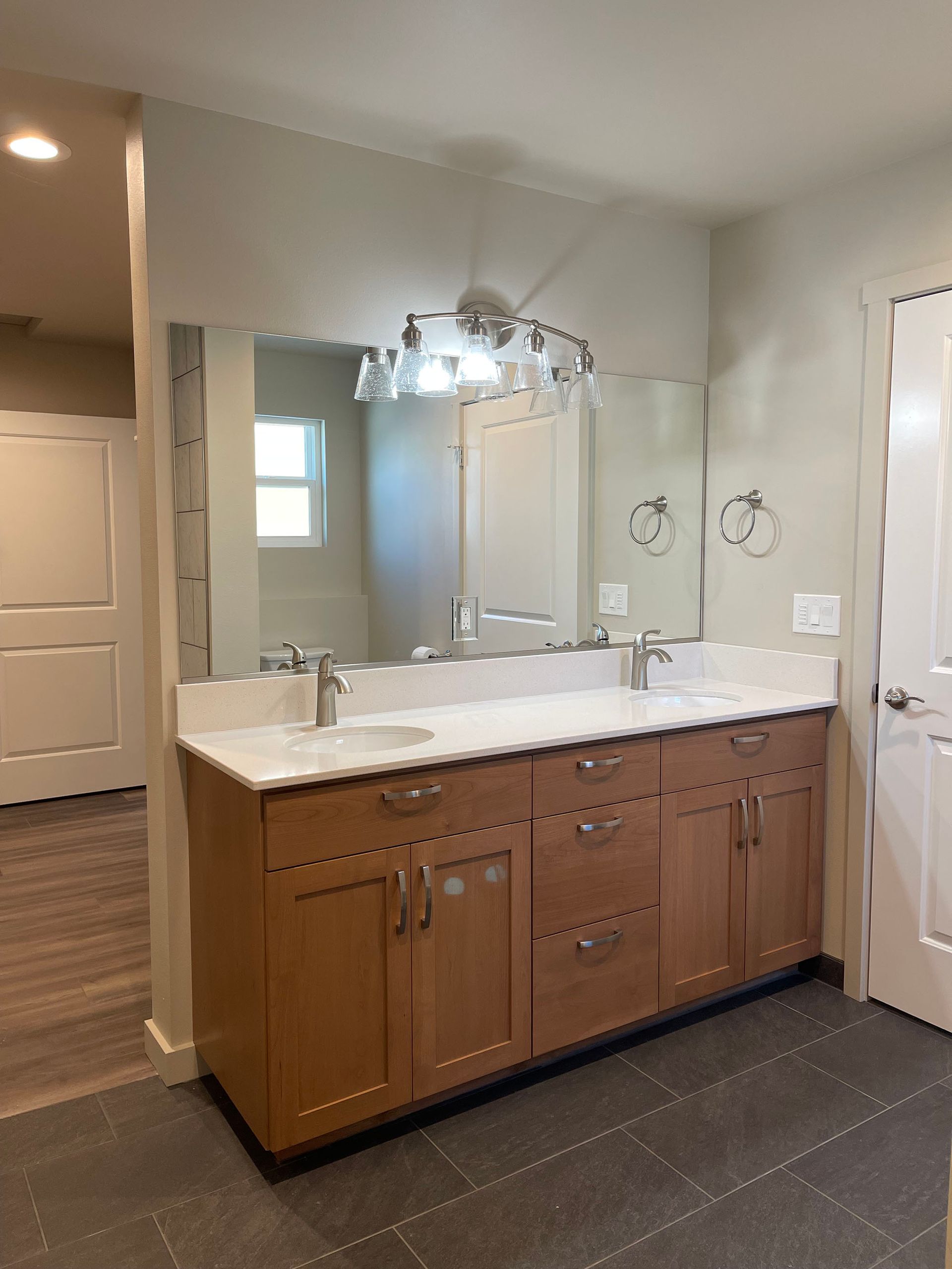 A bathroom with two sinks and a large mirror.
