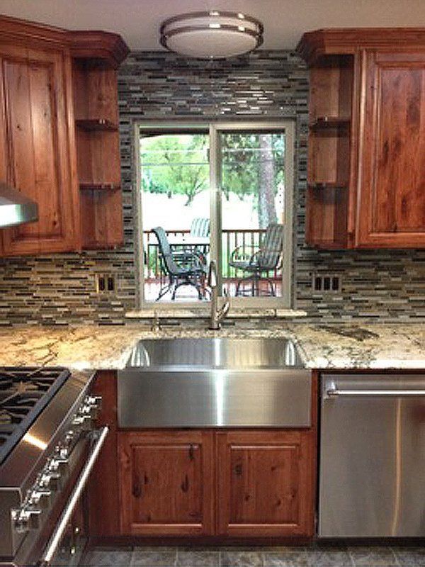 A kitchen with stainless steel appliances and wooden cabinets