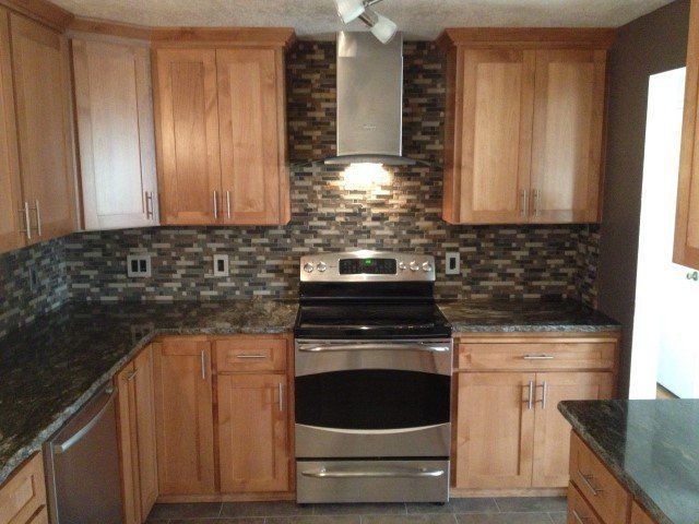 A kitchen with stainless steel appliances and wooden cabinets