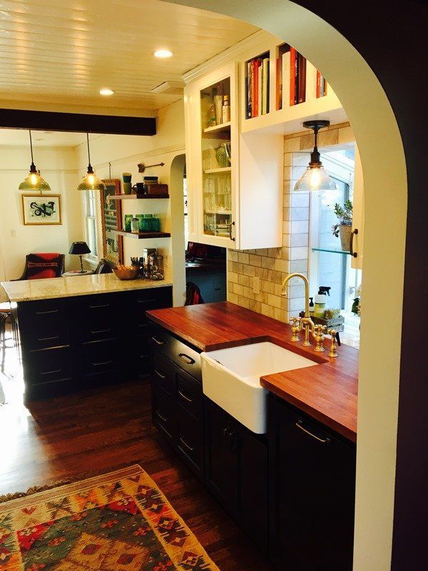 A kitchen with a sink and a rug on the floor