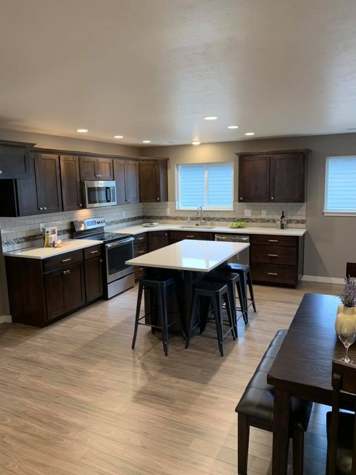 A kitchen with granite counter tops and wooden cabinets