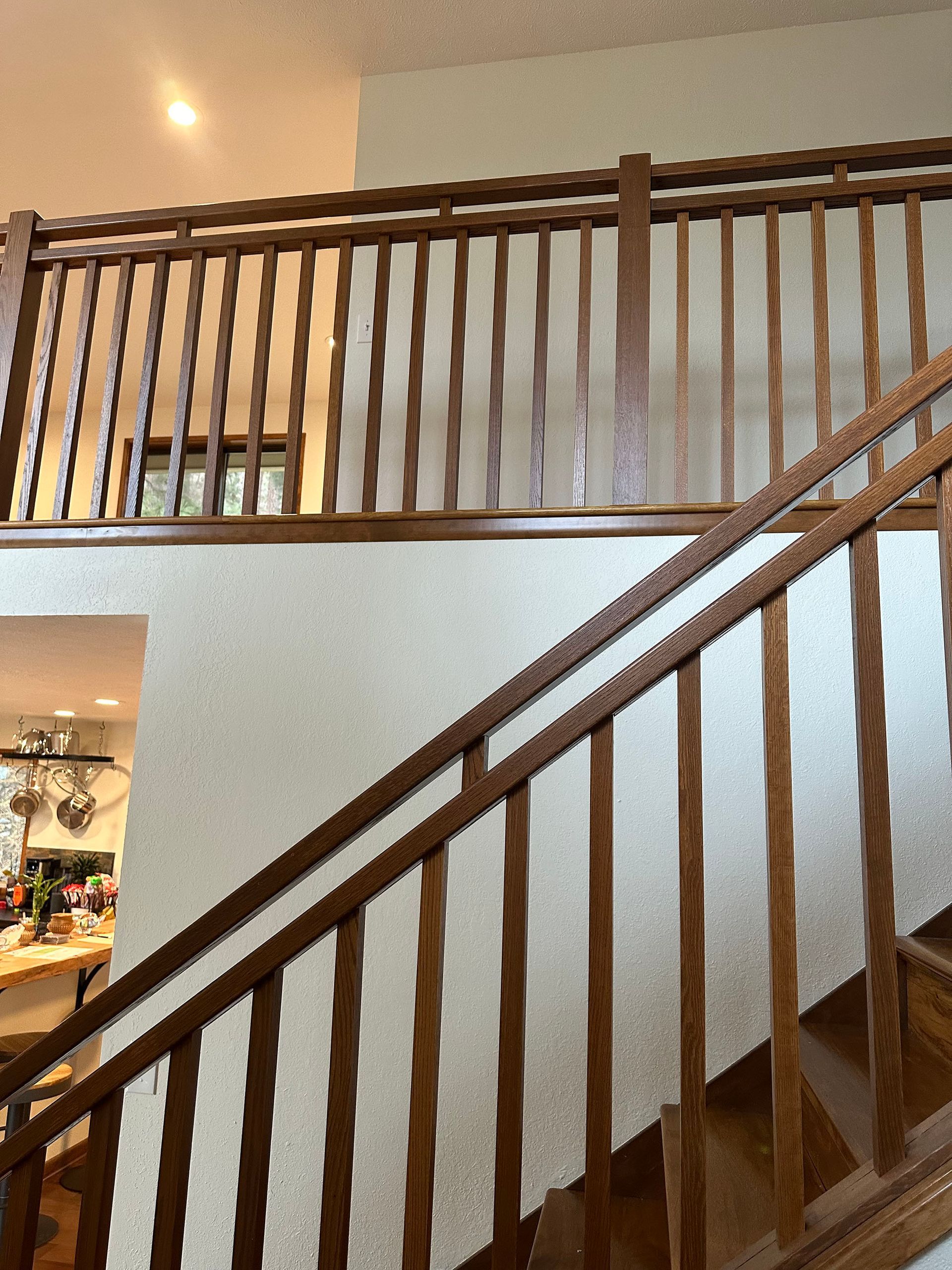 A staircase with a wooden railing in a house