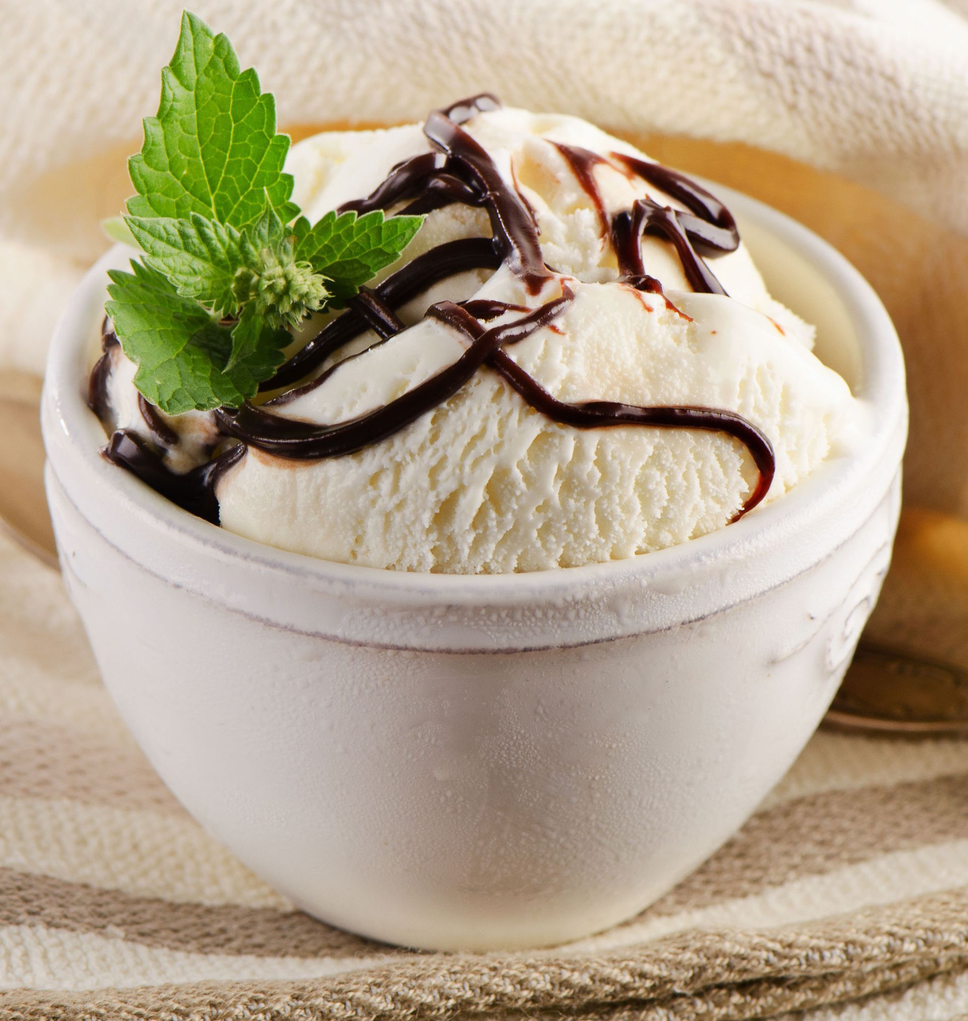 Chocolate-covered ice cream bar on a wooden stick.
