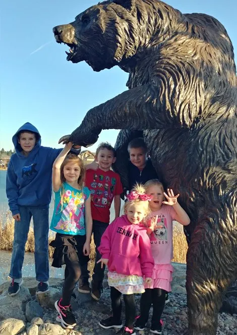 Kids with a bear statue