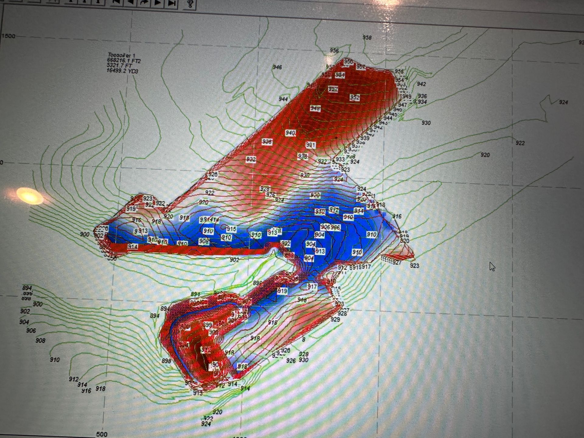Colored weather map with red and blue shaded zones over contour lines and a grid background