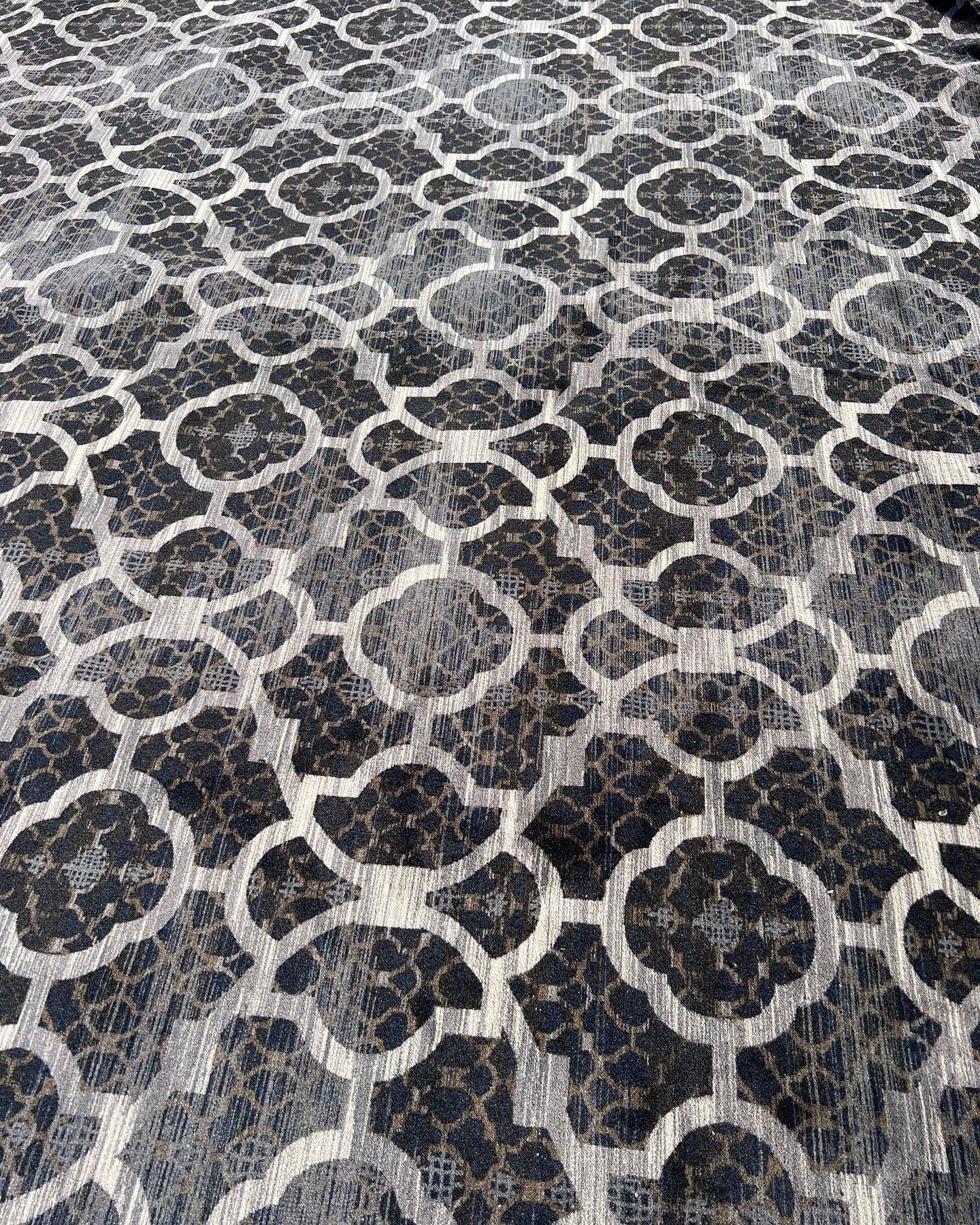 A close up of a black and white rug with a pattern on it.