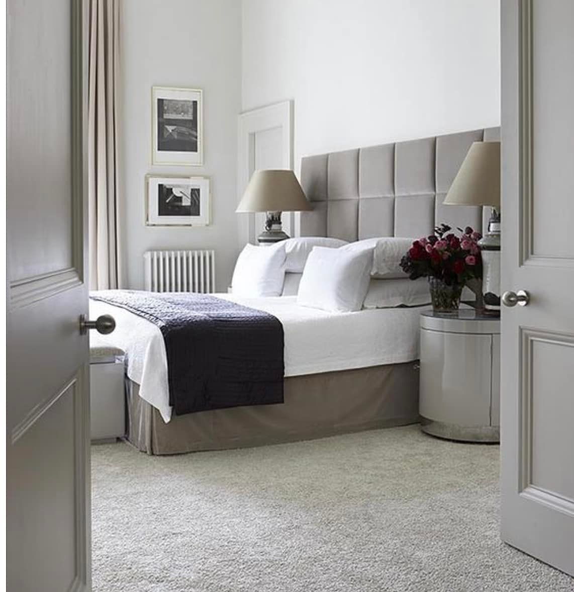 A bedroom with a king size bed and two nightstands