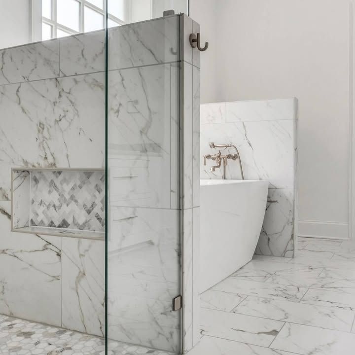 A bathroom with marble tiles and a bathtub