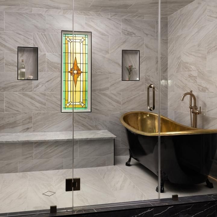 A bathroom with a bathtub and a stained glass window