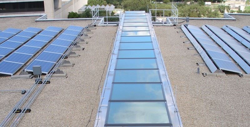 A row of solar panels on the roof of a building