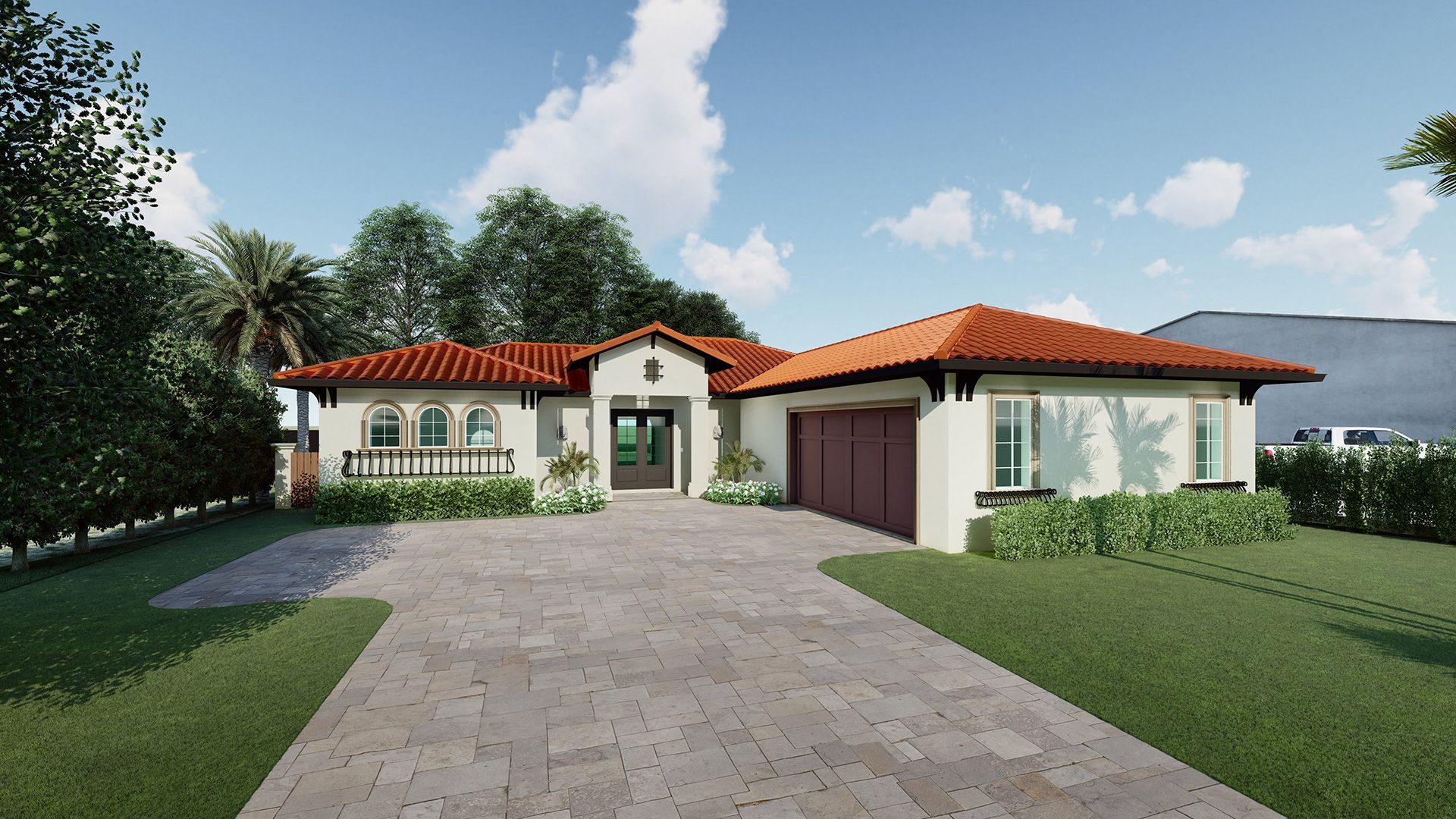 A stucco house with a red tile roof and a brick driveway on a sunny day.