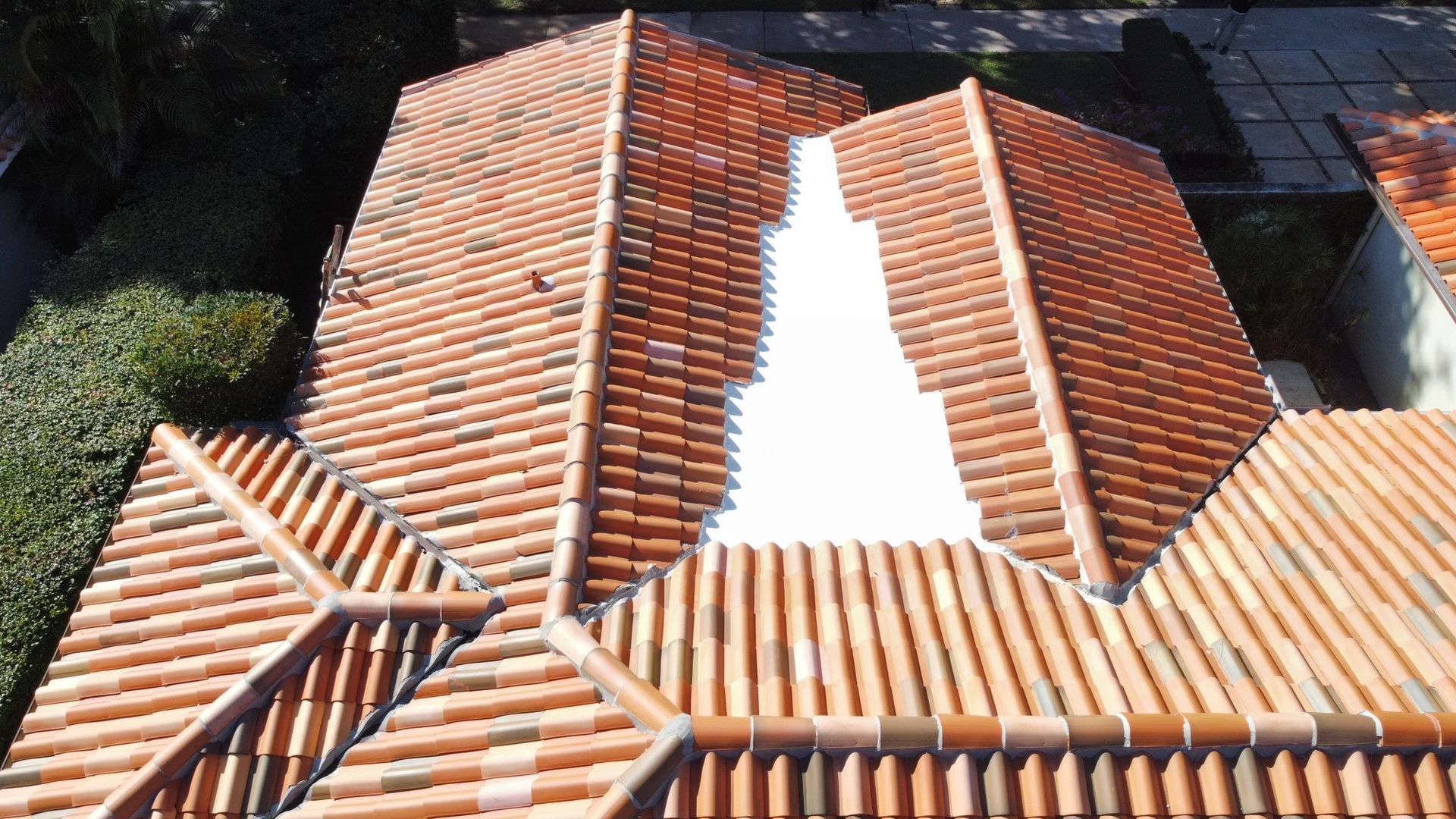 An aerial view of a tiled roof with a hole in the middle