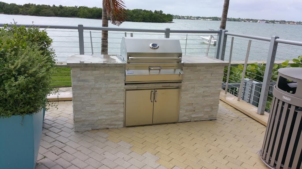 A stainless steel grill is sitting on a patio