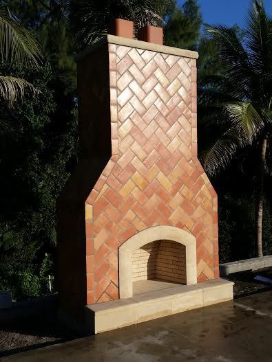 A large brick fireplace with a herringbone pattern