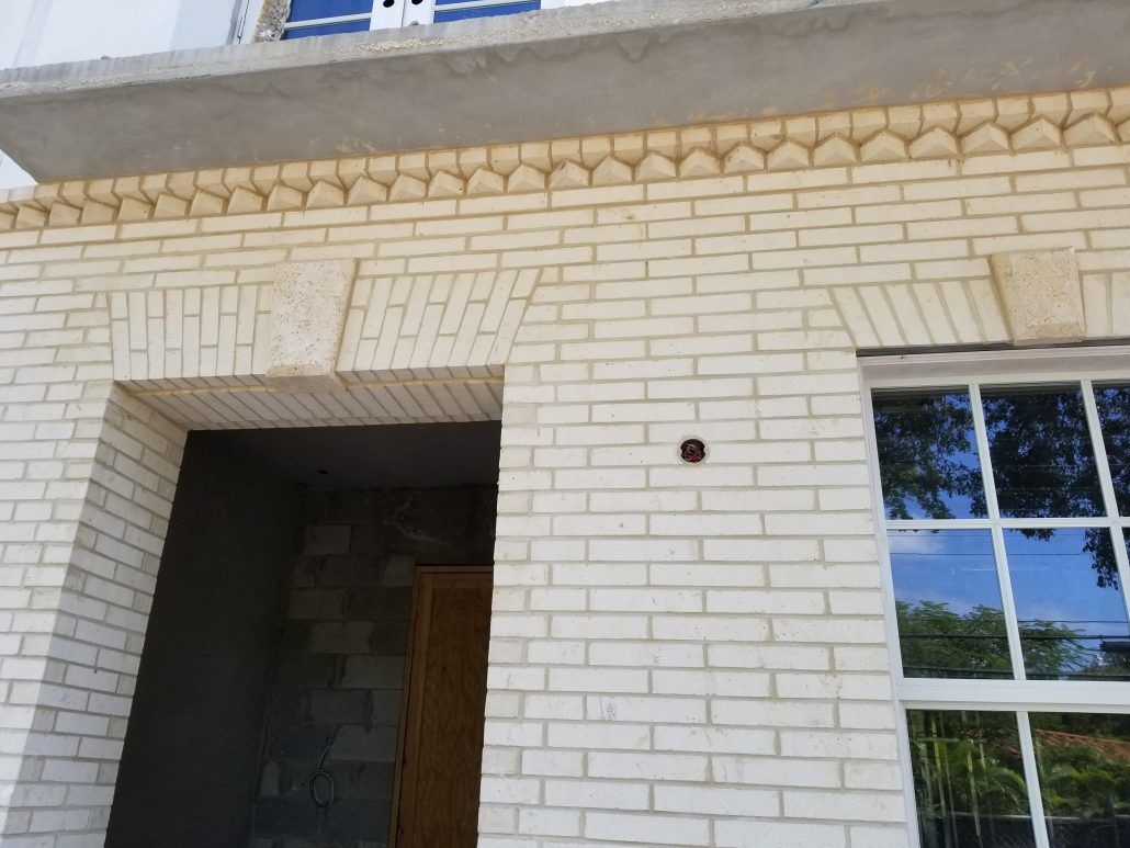 Close-up of a residential entrance with intricate brickwork in Parkland, FL.
