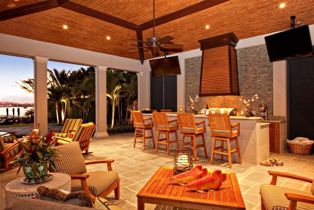 Outdoor living space with fan and dining set in Fort Lauderdale, FL.