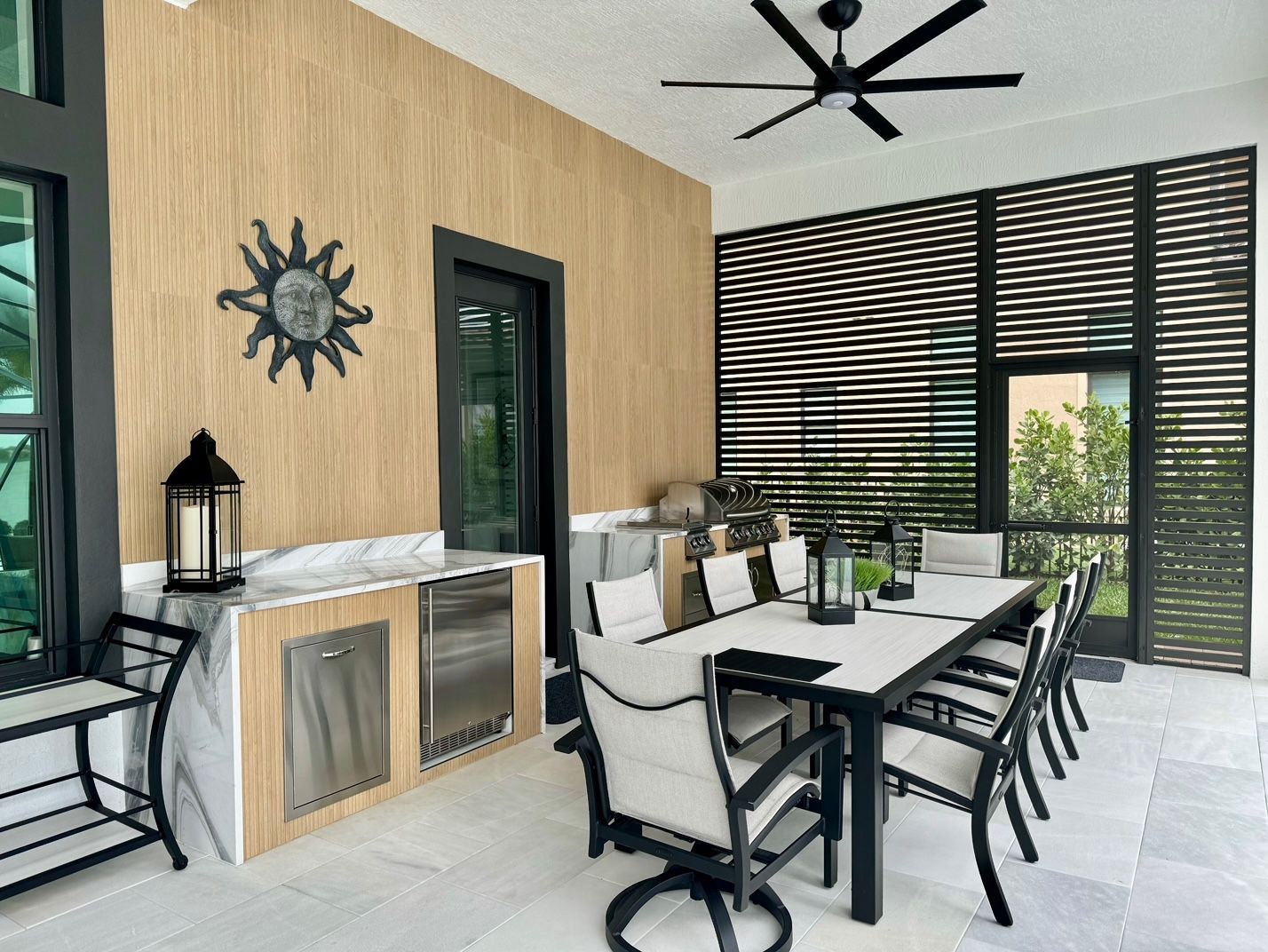Modern patio with ceiling fan and seating area in Lighthouse Point, FL.