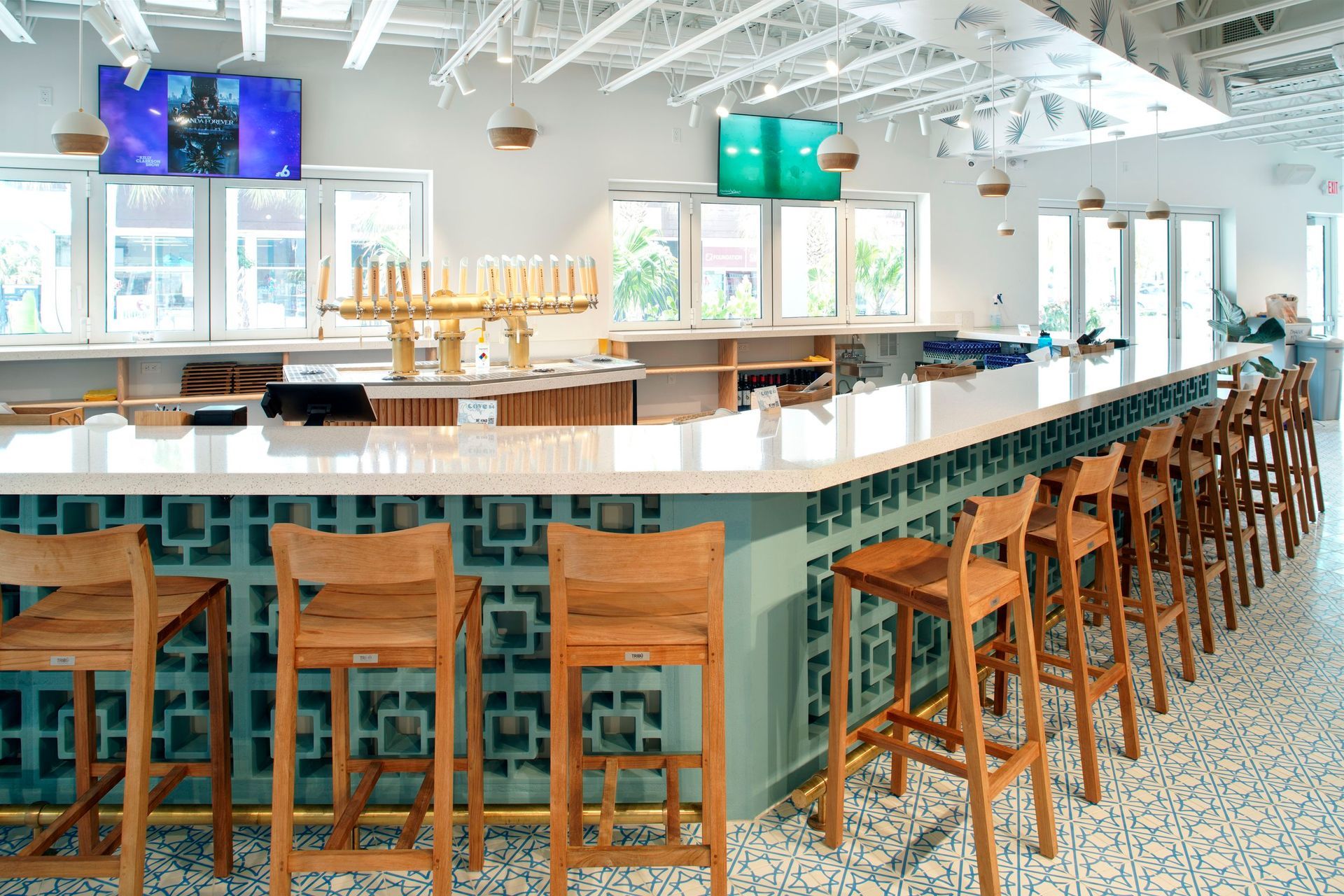 Interior of a restaurant featuring a stone bar and wooden seating in Fort Lauderdale, FL.