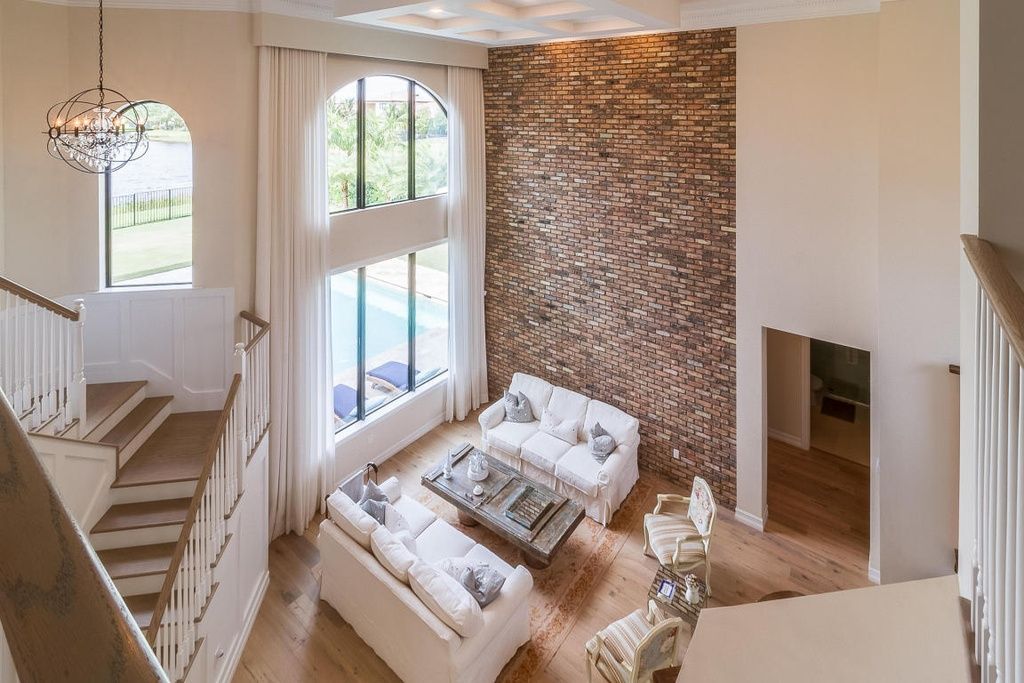 An aerial view of a living room with a couch and stairs.