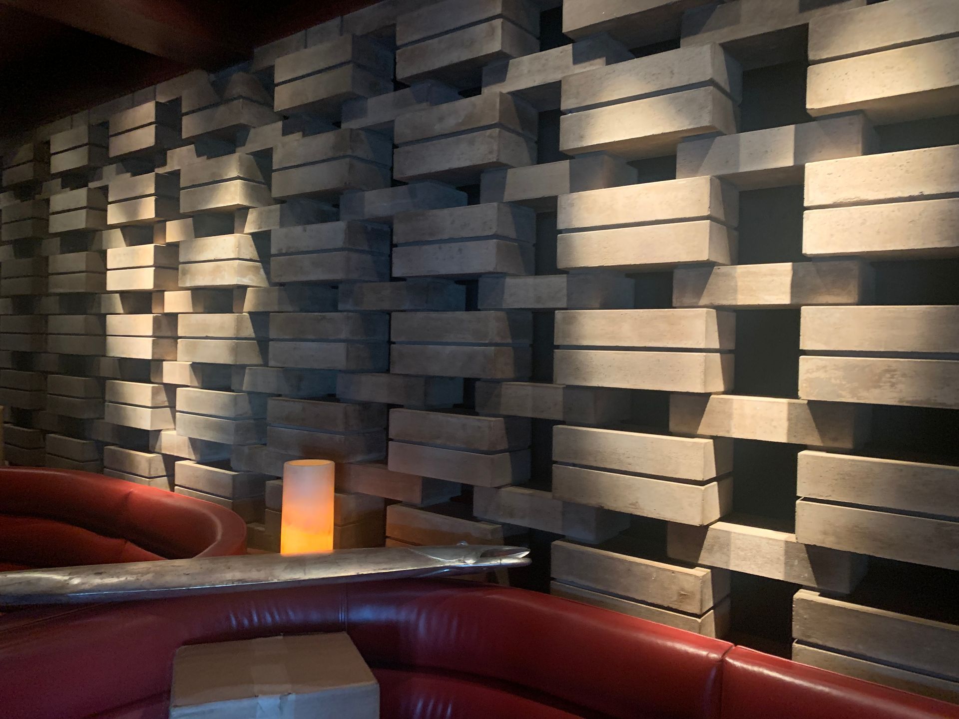 Modern indoor wall with geometric stone design and ambient lighting in Parkland, FL.