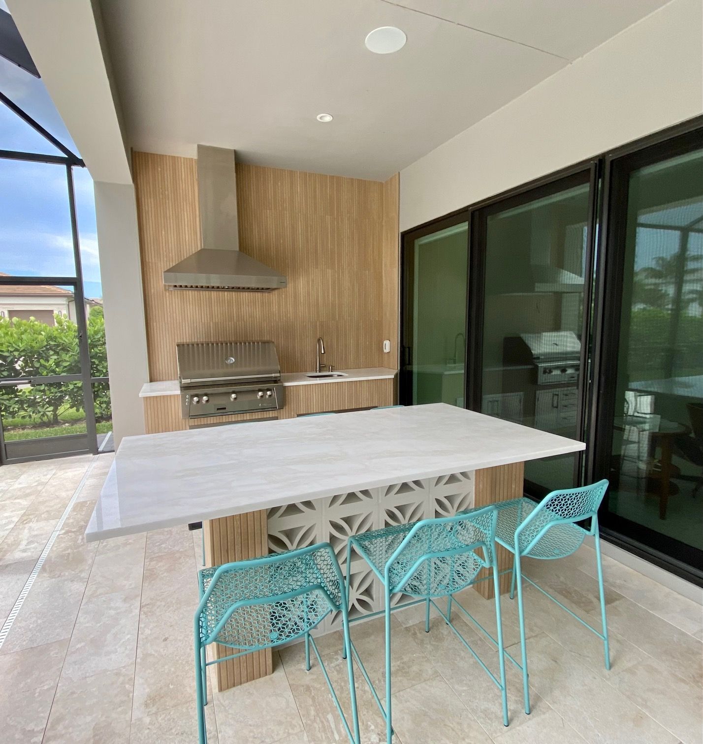 A kitchen with a table and chairs and a grill