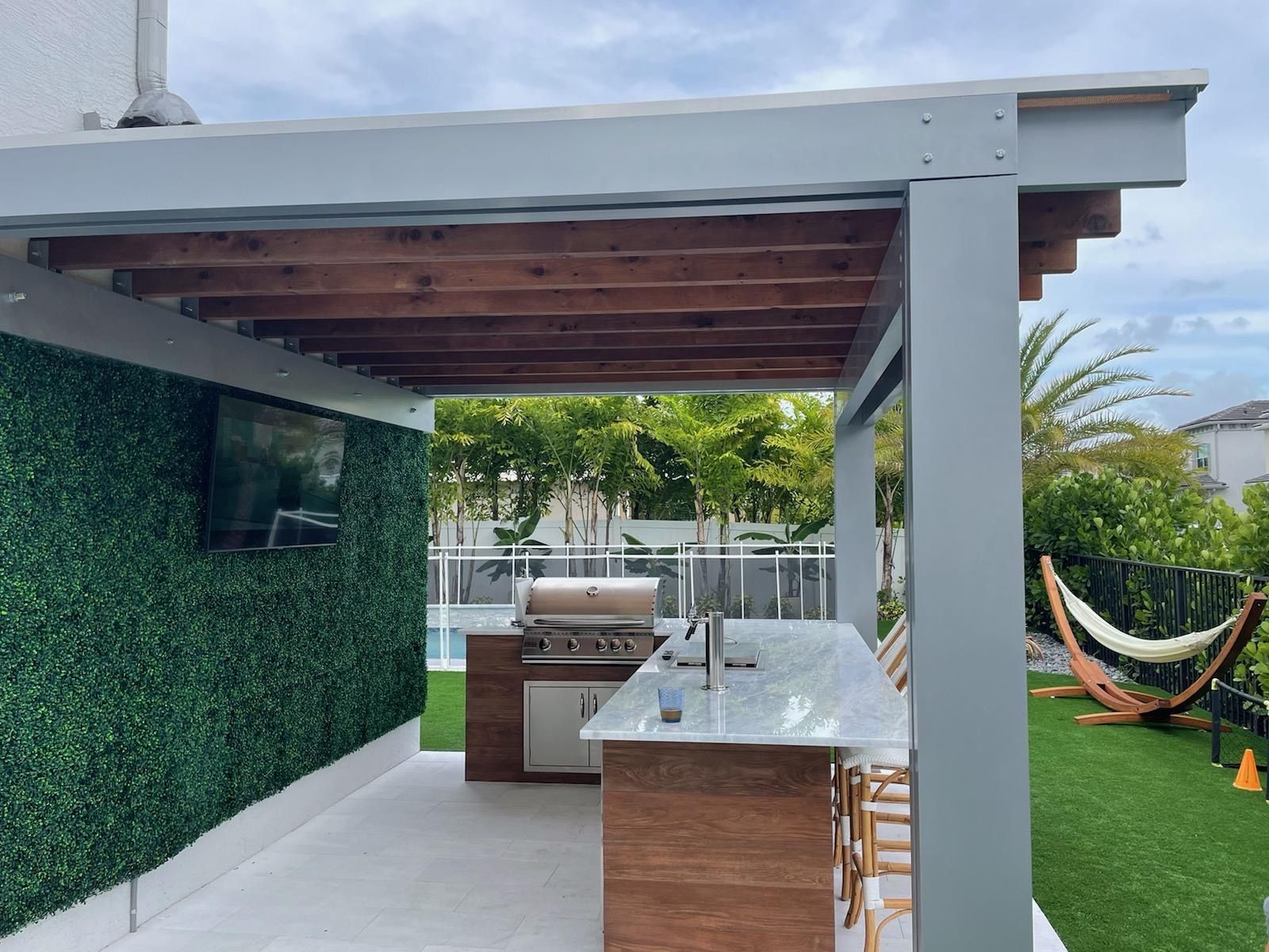 There is a grill and a hammock in the backyard.