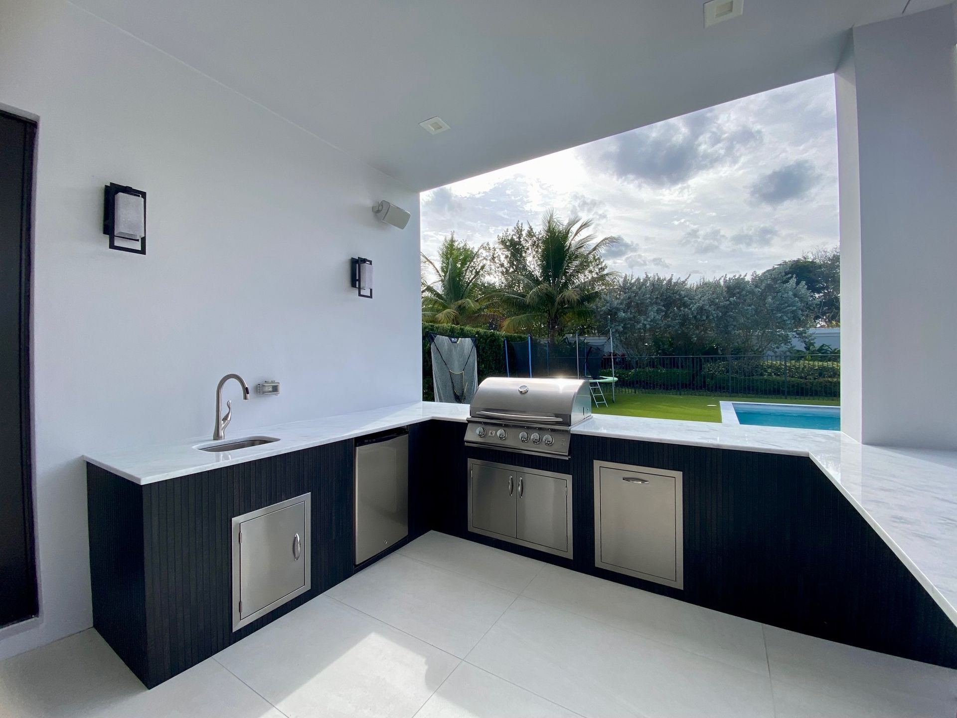 A kitchen with a grill and a sink in it